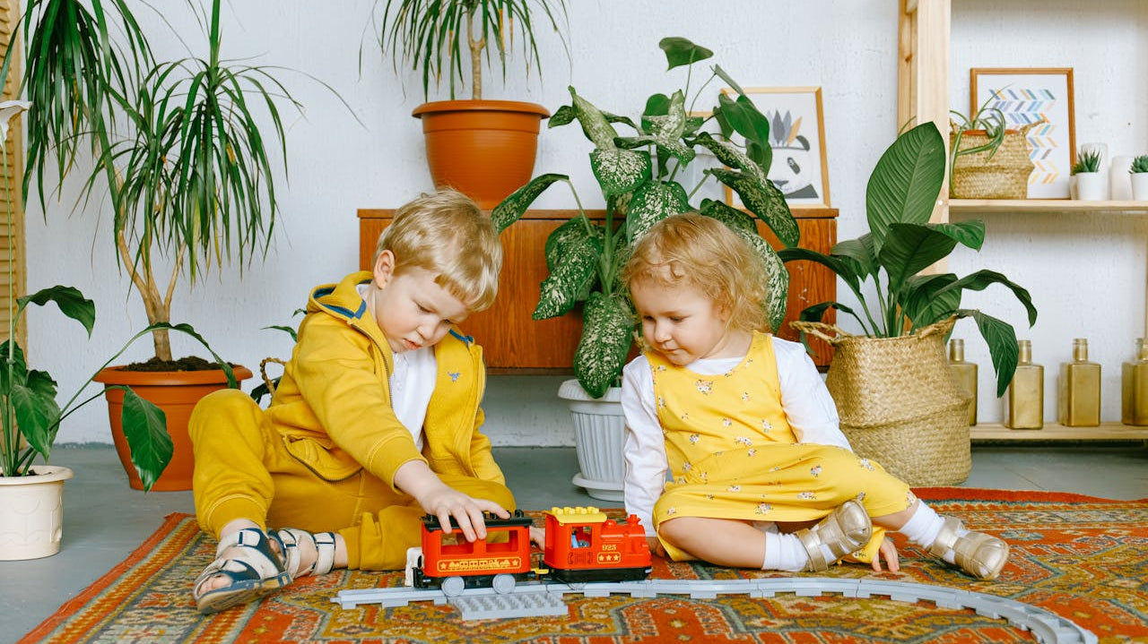 kids wearing yellow playing with potted plants at the background - Plant Studio