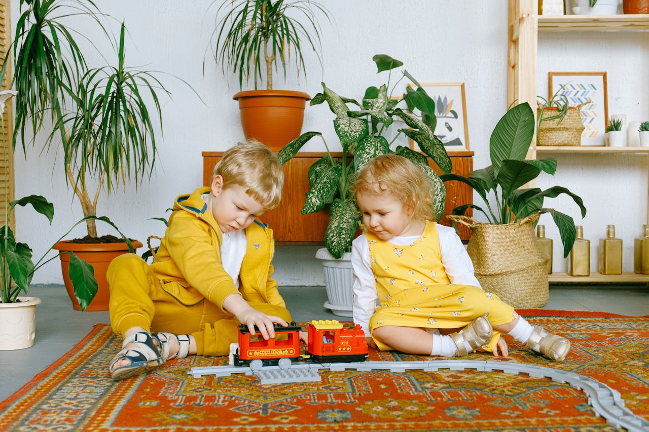 kids wearing yellow playing with potted plants at the background - Plant Studio